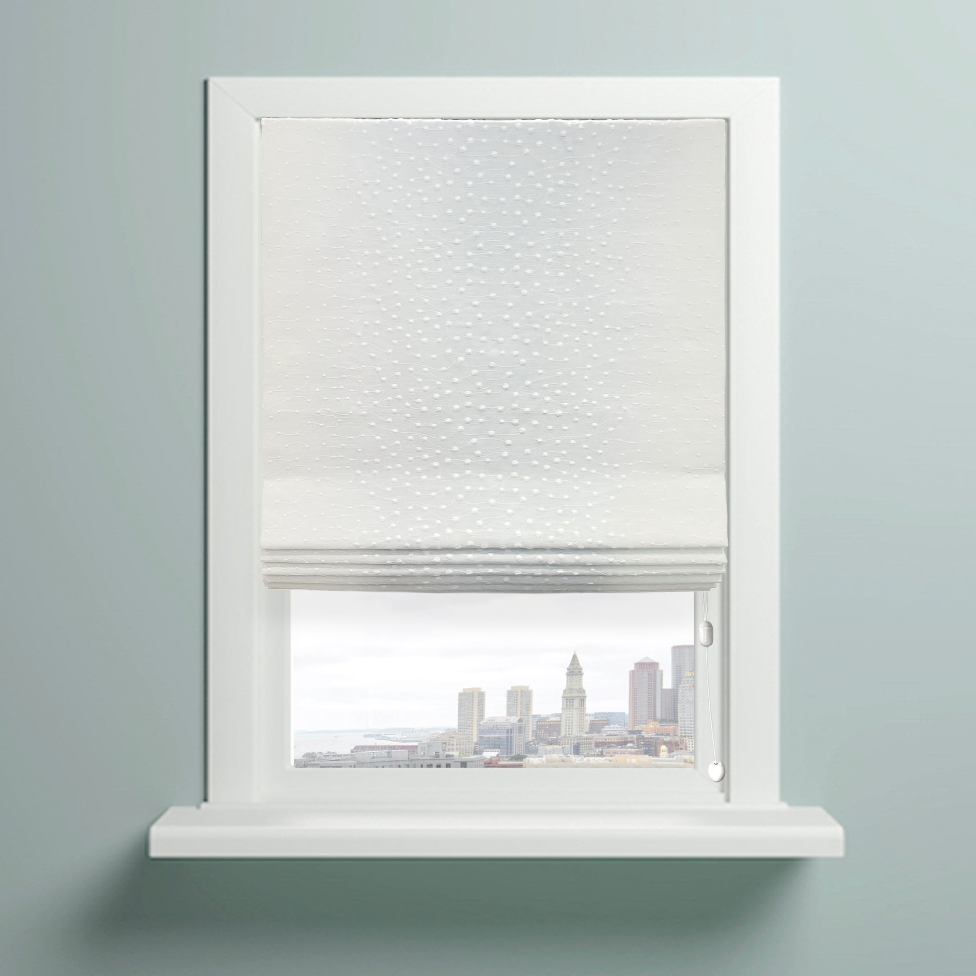 Elegant Embroidery Filigree Blend Linen flat roman shade on the window with a view of city.