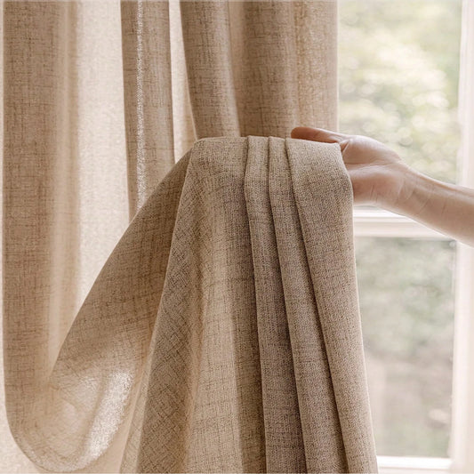 Beige curtain being held by a hand in front of a window