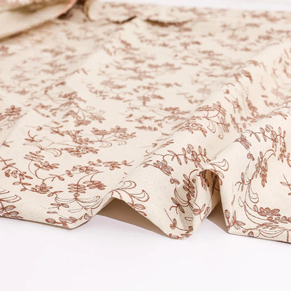 Floral patterned fabric with brown design on a white background