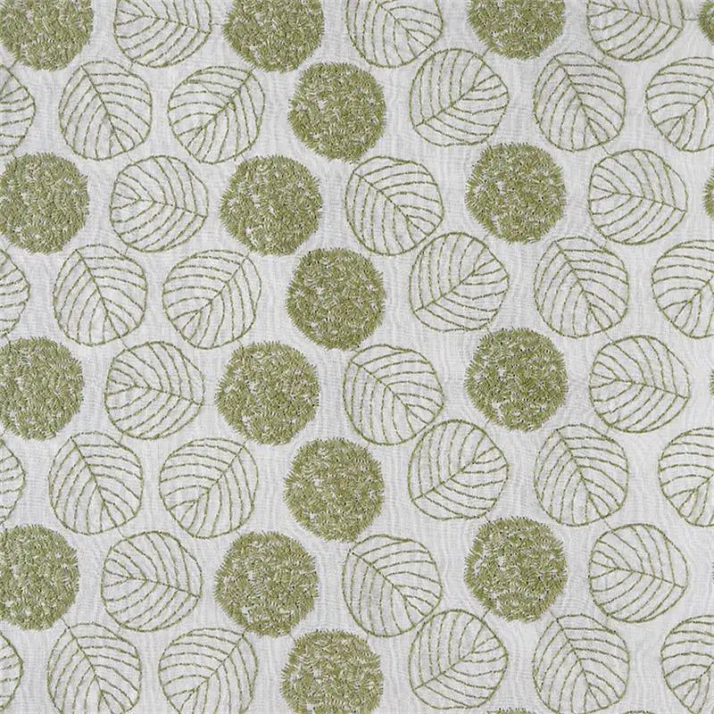 A close-up of a fabric or wallpaper pattern featuring sage green textured circles with leaf line drawings on a white background.