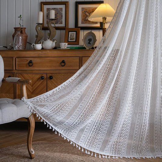 Lace curtain draped over a chair in a room with wooden furniture and decor.