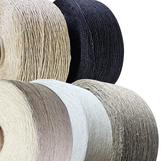 Five spools of braided cord or twine in various neutral colors, including beige, black, taupe, white, and gray, arranged diagonally on a white background.