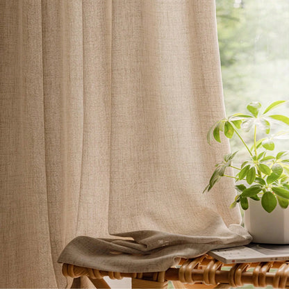 Beige curtain with a plant and table in the background