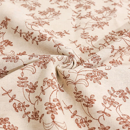 Close-up of beige fabric with subtle brown floral pattern