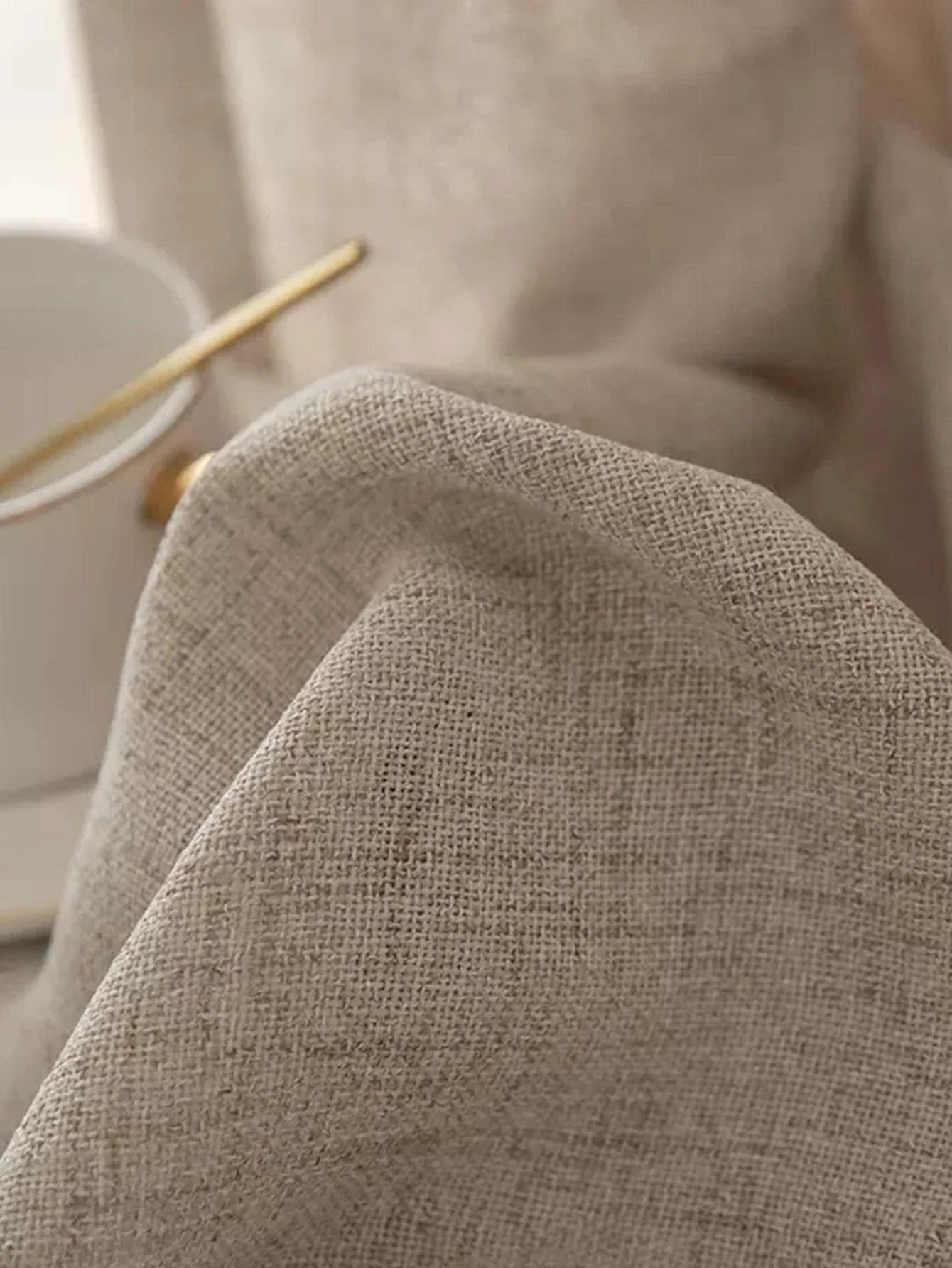 Close-up of a textured beige fabric with a blurred background