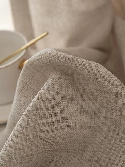 Close-up of a textured beige fabric with a blurred background