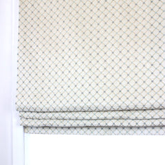 Patterned roman blind on a white background