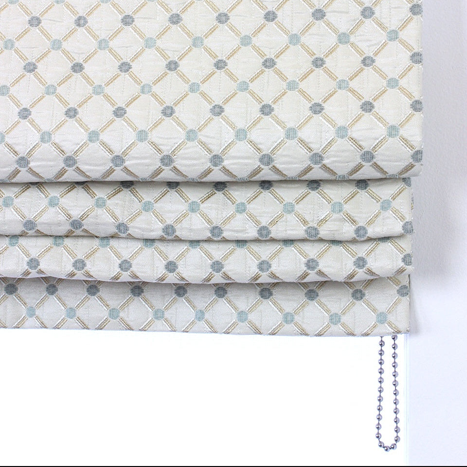 Patterned roman blind with geometric design on a white background