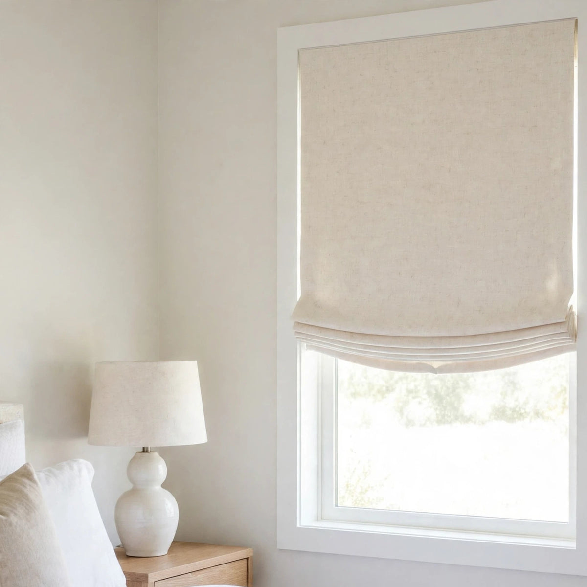 Vanilla double width linen relaxed Roman shade with a shallow curved bottom in a modern farmhouse bedroom