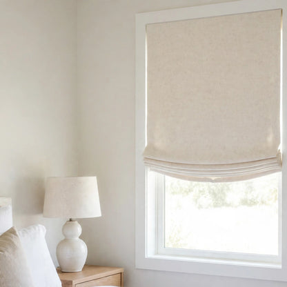 Vanilla double width linen relaxed Roman shade with a shallow curved bottom in a modern farmhouse bedroom