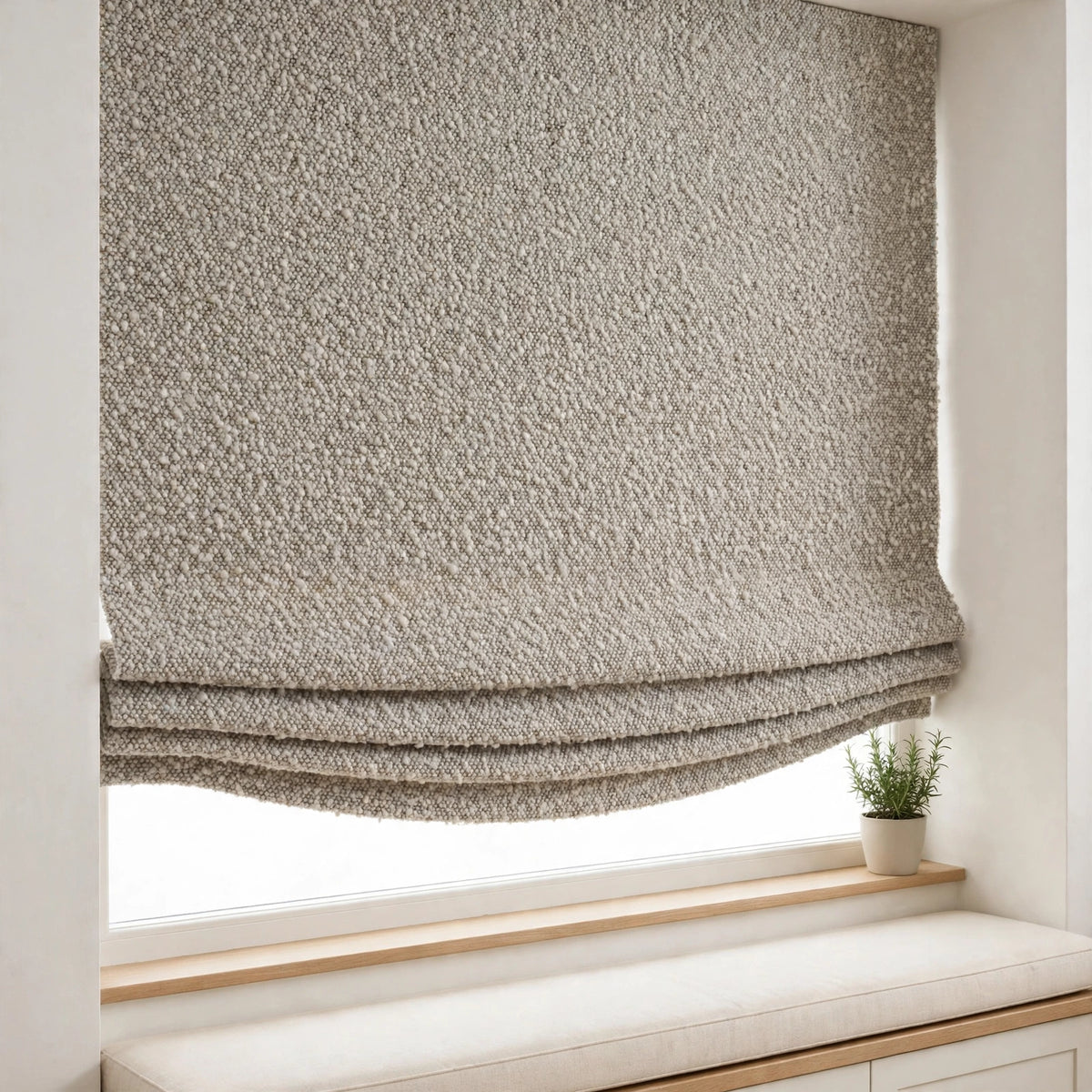 Pebble piling texture relaxed Roman shade with soft folds and a shallow curved bottom in a breakfast nook