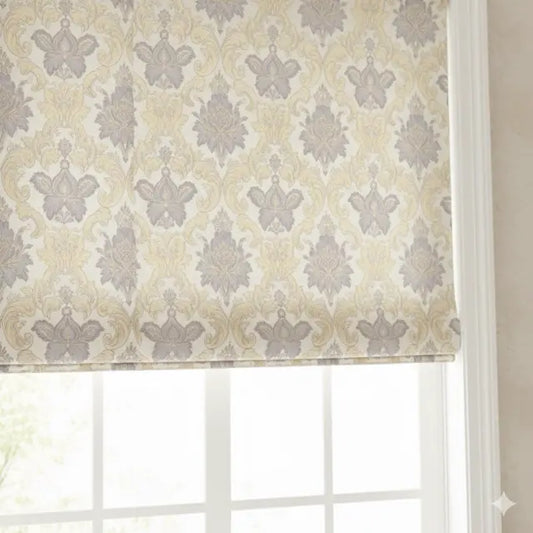 Window with a patterned roman shade in beige and gray tones.