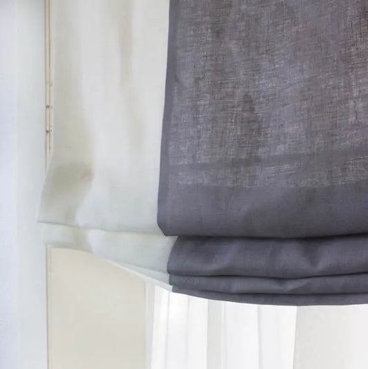Gray roman shade against a white background