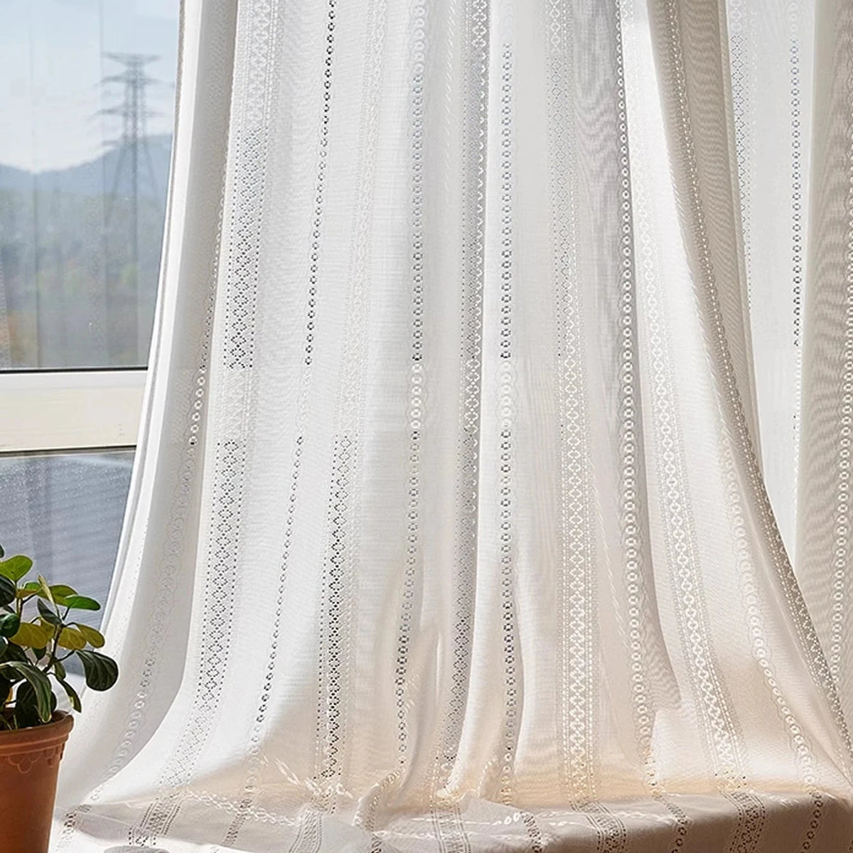 White lace sheer curtain draped over a window seat in natural light, CD1049