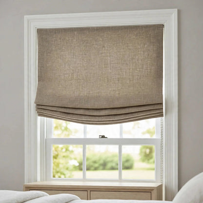 Natural Belgian linen relaxed Roman shade half raised with soft compact folds in a serene bedroom