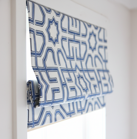 Blue geometric patterned roman blind on a window