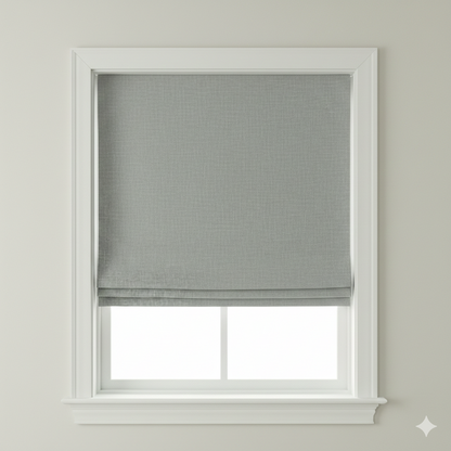 soft sheer linen flat roman shade with a blackout lining on a window with a white frame against a light gray wall