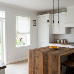 Modern kitchen with a white linen relaxed roman shade, wooden island and white cabinets.