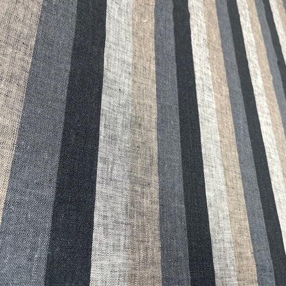 Natural linen fabric with dark vertical stripes in black, gray, and beige tones, laid flat.