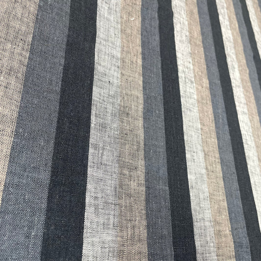 Natural linen fabric with dark vertical stripes in black, gray, and beige tones, laid flat.