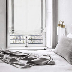 White linen relaxed shade with grey border in a linen duvet bed