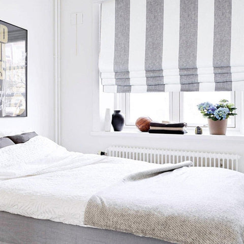 wide white grey striped linen wide flat roman shade on the bedroom